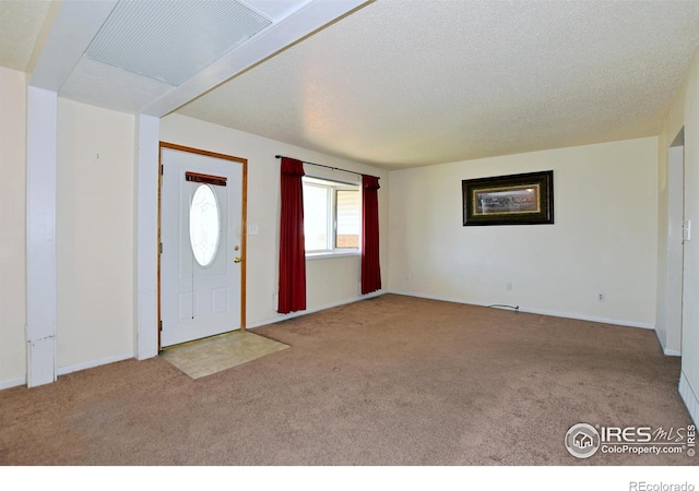 carpeted entrance foyer featuring baseboards and visible vents