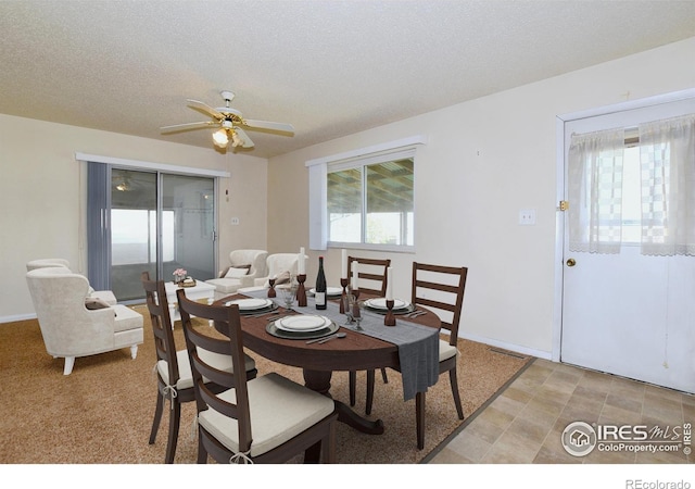 dining room featuring visible vents, a textured ceiling, and ceiling fan