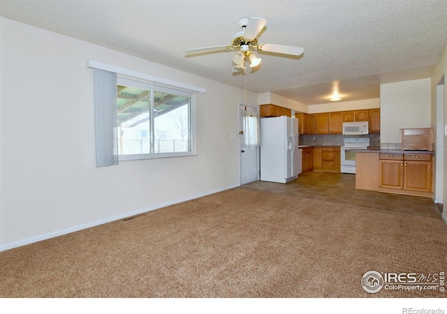 kitchen with dark colored carpet, visible vents, open floor plan, and white appliances