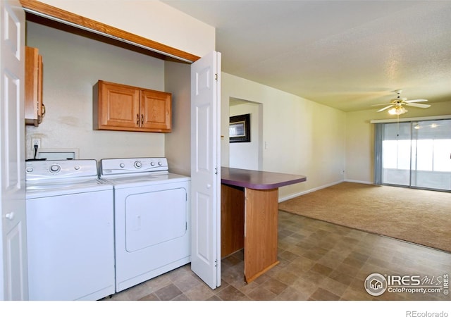 laundry area featuring carpet floors, washing machine and clothes dryer, baseboards, cabinet space, and ceiling fan