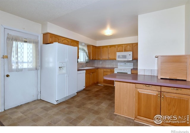 kitchen with light floors, decorative backsplash, a sink, and white appliances