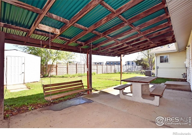 view of patio / terrace with central AC, an outbuilding, a fenced backyard, and a storage shed