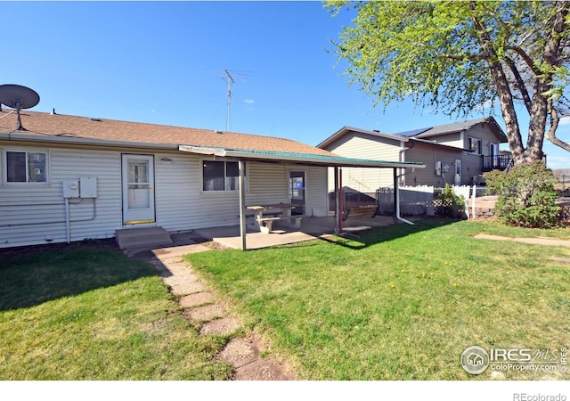 rear view of house featuring a lawn, fence, a patio area, and entry steps