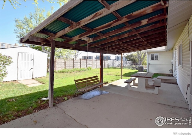 view of patio with central air condition unit, an outdoor structure, fence, and a storage unit