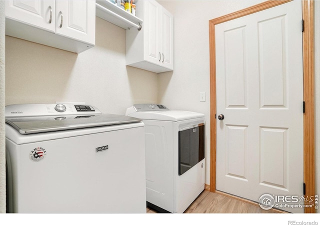 9040 Painted Horse Ln, Wellington, CO 80549 - laundry room with separate washer and dryer, light wood-style floors, and cabinet space