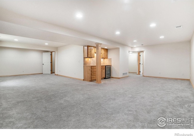 9040 Painted Horse Ln, Wellington, CO 80549 - unfurnished living room featuring recessed lighting, visible vents, and light carpet