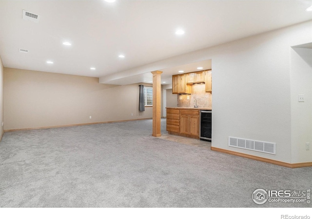 9040 Painted Horse Ln, Wellington, CO 80549 - unfurnished living room with light carpet, beverage cooler, visible vents, and recessed lighting