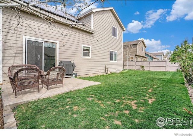 9040 Painted Horse Ln, Wellington, CO 80549 - rear view of property with fence, a lawn, and a patio