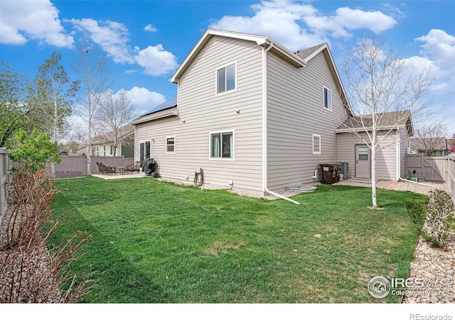 9040 Painted Horse Ln, Wellington, CO 80549 - rear view of house featuring a fenced backyard, a yard, and a patio