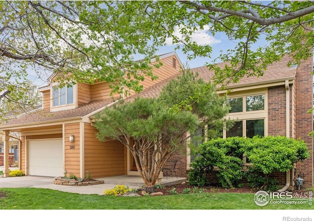 5285 Gallatin Pl, Boulder, CO 80303 - view of front of house with an attached garage, driveway, and brick siding