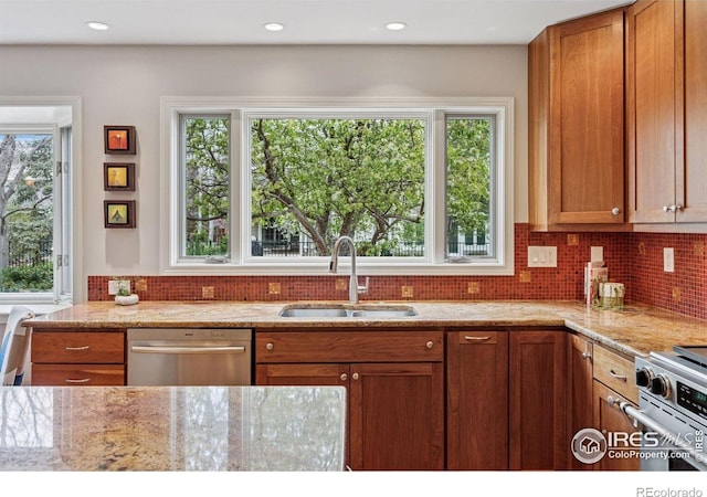 5285 Gallatin Pl, Boulder, CO 80303 - kitchen with light stone countertops, a sink, brown cabinets, and appliances with stainless steel finishes