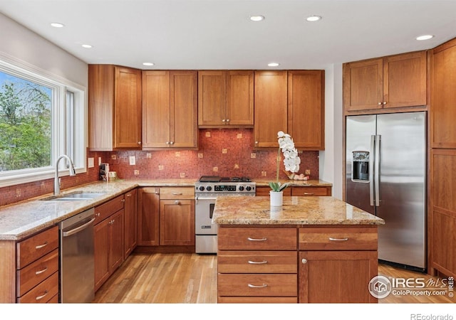 5285 Gallatin Pl, Boulder, CO 80303 - kitchen with light wood-style flooring, a sink, brown cabinets, and appliances with stainless steel finishes