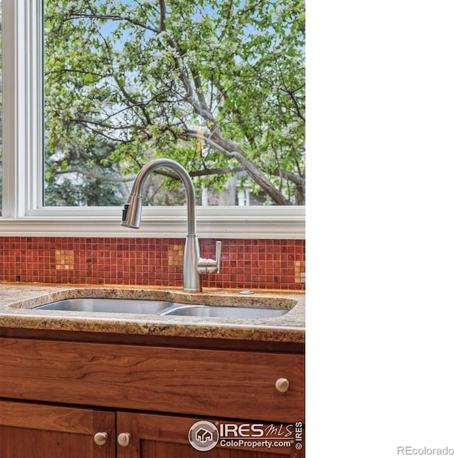 5285 Gallatin Pl, Boulder, CO 80303 - details featuring brown cabinets, tasteful backsplash, and a sink