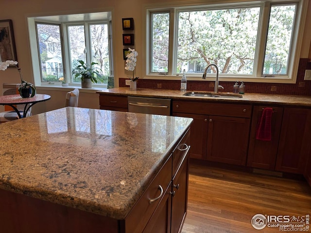 5285 Gallatin Pl, Boulder, CO 80303 - kitchen featuring a center island, a sink, light wood-style floors, light stone counters, and dishwasher