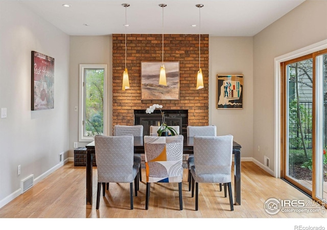 5285 Gallatin Pl, Boulder, CO 80303 - dining room with baseboards, light wood-style flooring, visible vents, and a fireplace