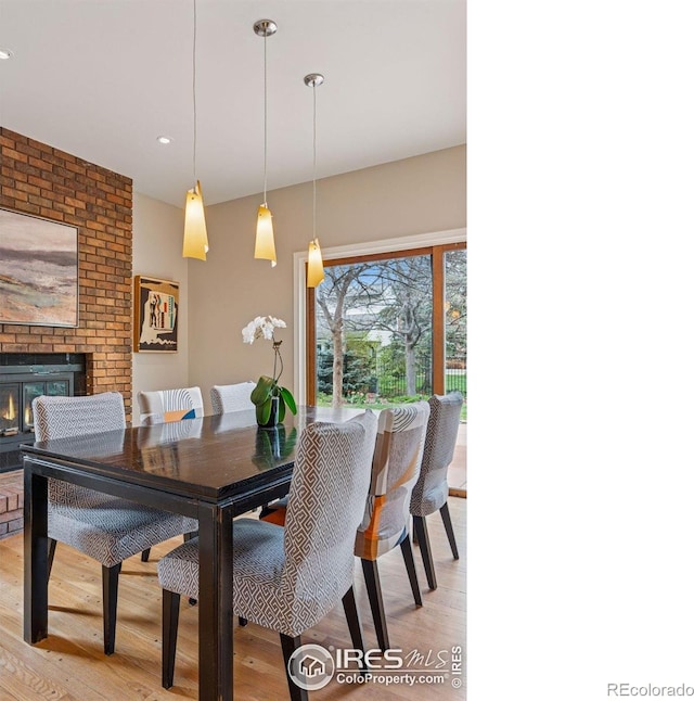 5285 Gallatin Pl, Boulder, CO 80303 - dining area with light wood-style floors and a fireplace
