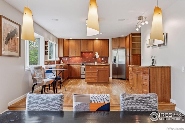 5285 Gallatin Pl, Boulder, CO 80303 - kitchen with open shelves, brown cabinetry, light wood-style flooring, backsplash, and appliances with stainless steel finishes