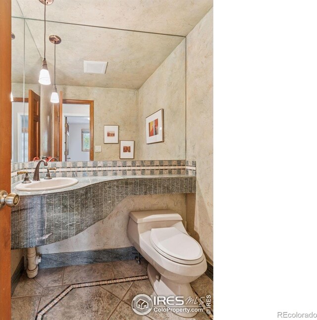 5285 Gallatin Pl, Boulder, CO 80303 - bathroom with toilet, tile patterned flooring, and a sink