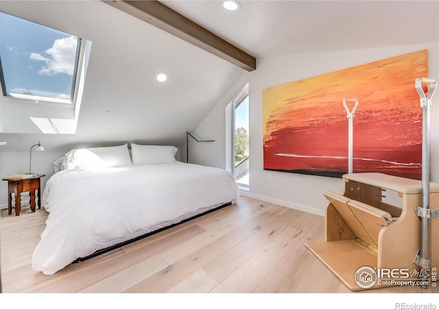 bedroom featuring recessed lighting, vaulted ceiling with skylight, wood finished floors, and baseboards