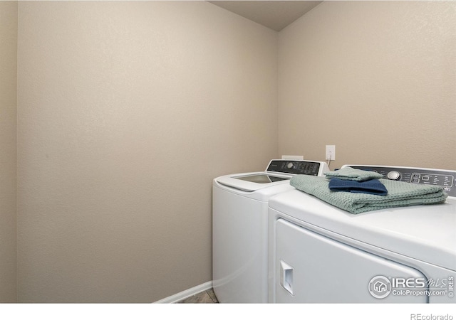 laundry room featuring baseboards, laundry area, and washer and clothes dryer