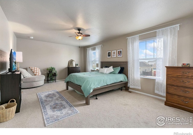 carpeted bedroom featuring a ceiling fan and baseboards