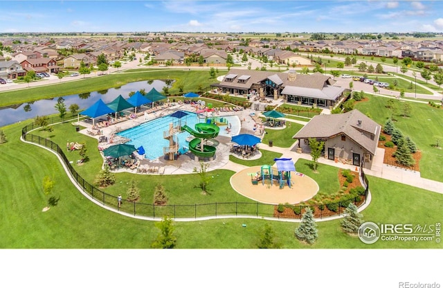 drone / aerial view with a water view and a residential view