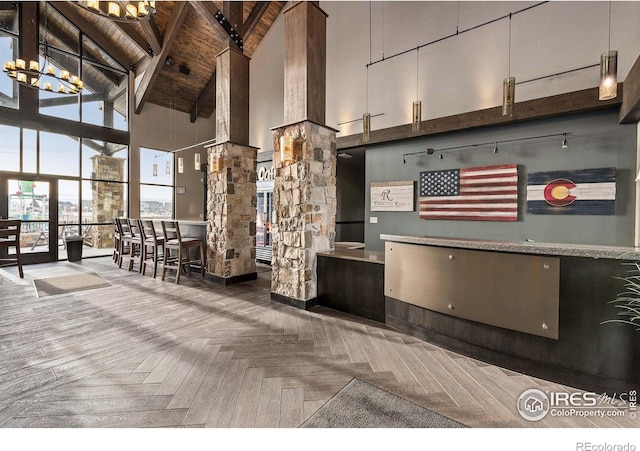welcome area with decorative columns and a chandelier