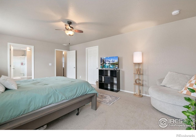 carpeted bedroom featuring baseboards, a ceiling fan, and ensuite bathroom