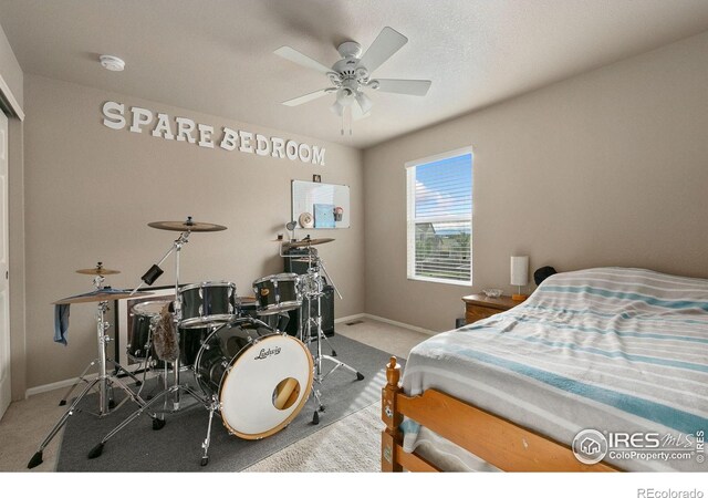 bedroom with baseboards, ceiling fan, and carpet flooring