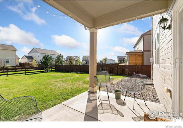 view of yard featuring a fenced backyard, a patio area, and a residential view