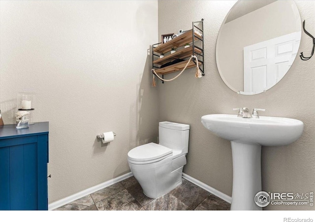 6747 Grainery Rd, Timnath, CO 80547 - bathroom featuring toilet, baseboards, and a sink
