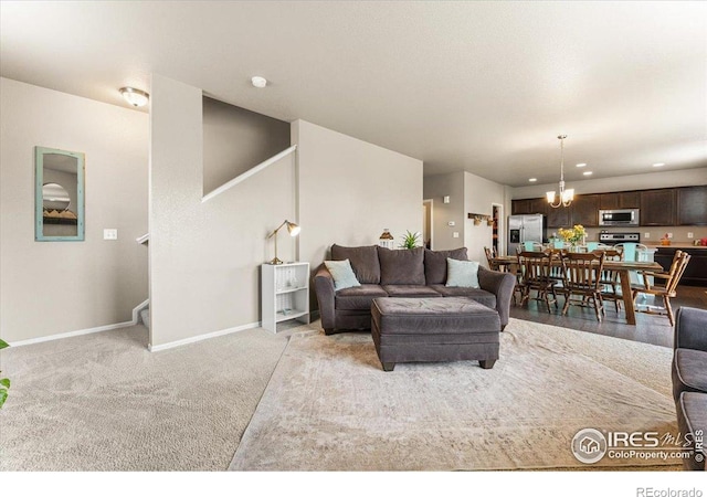 6747 Grainery Rd, Timnath, CO 80547 - living room with stairway, a chandelier, baseboards, light carpet, and recessed lighting