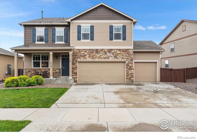 6747 Grainery Rd, Timnath, CO 80547 - craftsman inspired home with covered porch, stone siding, concrete driveway, and an attached garage