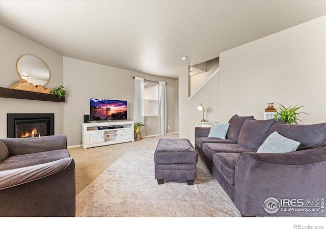 6747 Grainery Rd, Timnath, CO 80547 - carpeted living room featuring a glass covered fireplace and baseboards