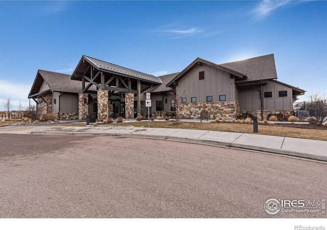 6747 Grainery Rd, Timnath, CO 80547 - view of front of home with board and batten siding and stone siding