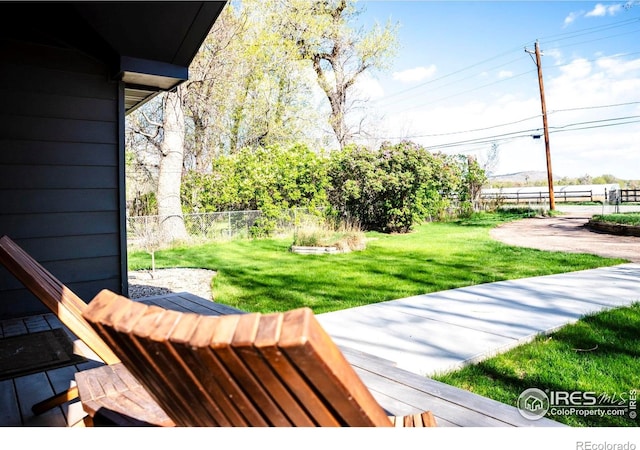 wooden deck featuring fence and a lawn
