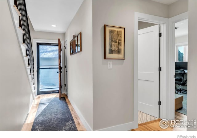 corridor featuring recessed lighting, baseboards, and light wood-type flooring