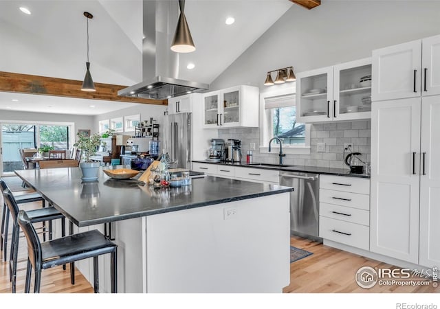 kitchen featuring a sink, stainless steel appliances, recessed lighting, island exhaust hood, and light wood-type flooring