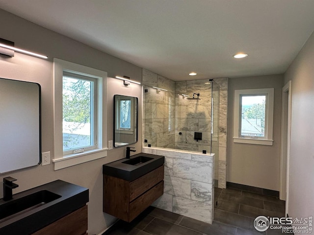 full bath featuring a sink, a walk in shower, and a wealth of natural light