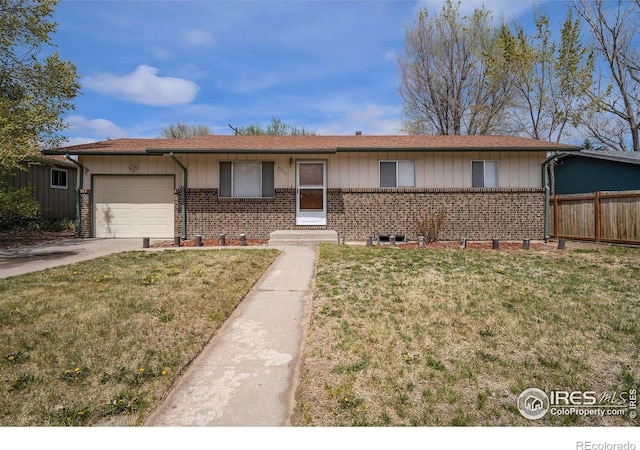 single story home featuring a garage, driveway, fence, a front yard, and brick siding
