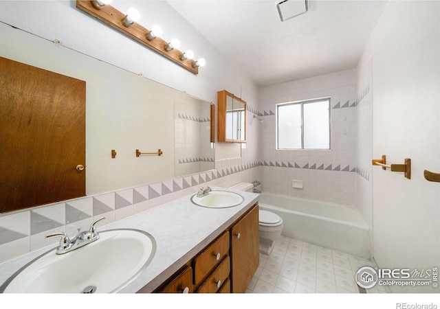 full bath featuring tile patterned floors, a sink, double vanity, and toilet