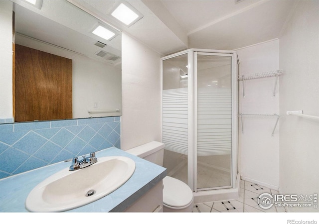 bathroom with vanity, toilet, tile patterned flooring, and a stall shower