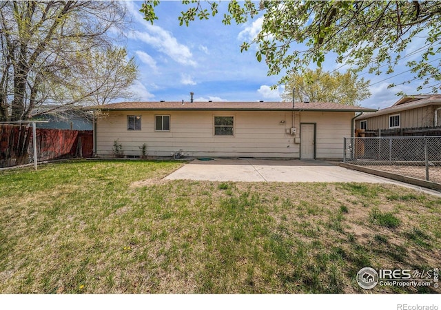 back of property featuring a yard, a patio area, and a fenced backyard