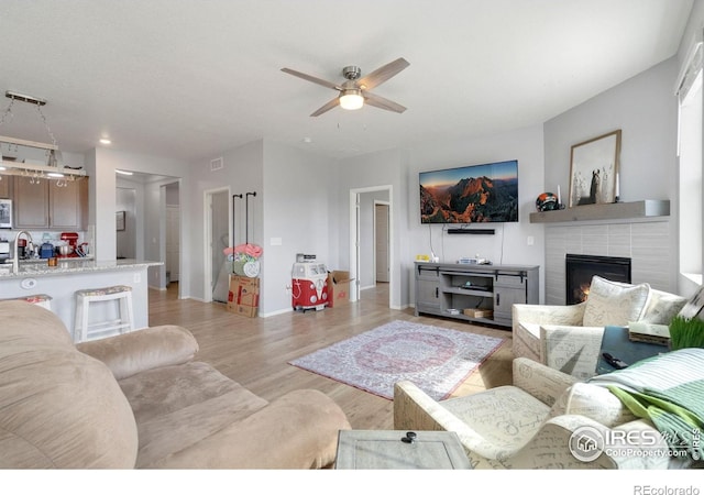 2000 Rose Petal Dr, Windsor, CO 80550 - living area with a ceiling fan, a fireplace, light wood finished floors, baseboards, and recessed lighting