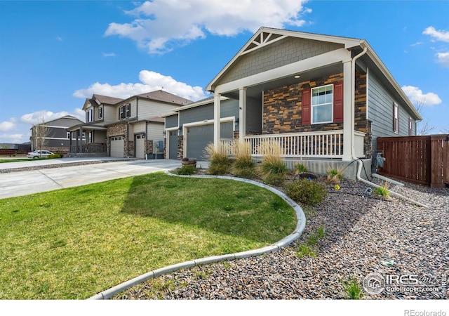 2000 Rose Petal Dr, Windsor, CO 80550 - craftsman inspired home featuring a porch, driveway, stone siding, and an attached garage