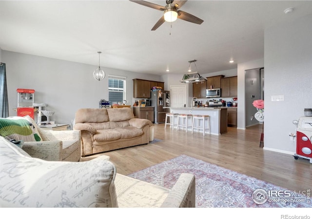 2000 Rose Petal Dr, Windsor, CO 80550 - living area with a ceiling fan, light wood-style floors, baseboards, and recessed lighting