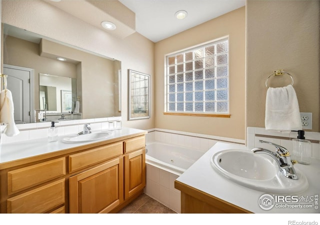 full bath with recessed lighting, vanity, tile patterned flooring, and a tub with jets