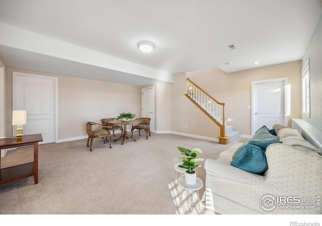 living room featuring carpet flooring, baseboards, visible vents, and stairs