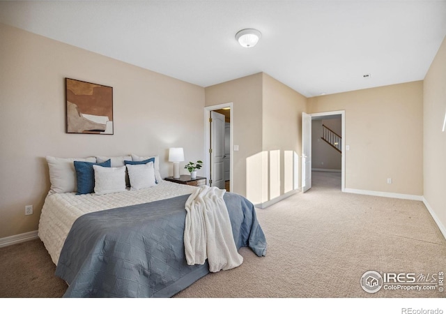 carpeted bedroom featuring baseboards