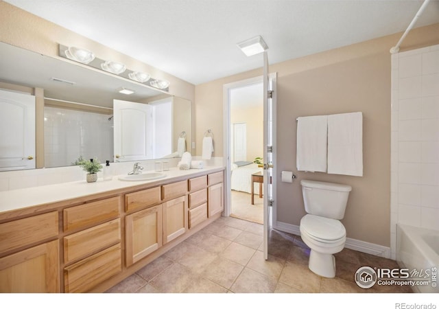 bathroom with toilet, baseboards, tile patterned flooring, and vanity